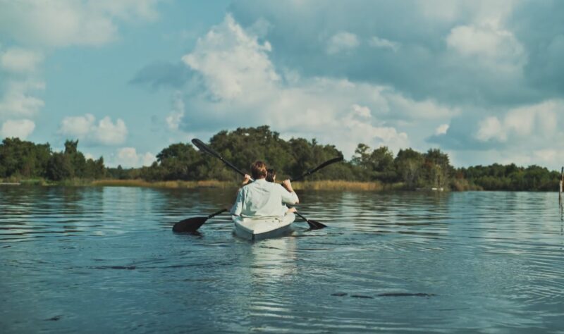 two people kayaking on a lake